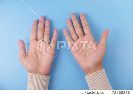 women hand with open palms on blue background  72868278