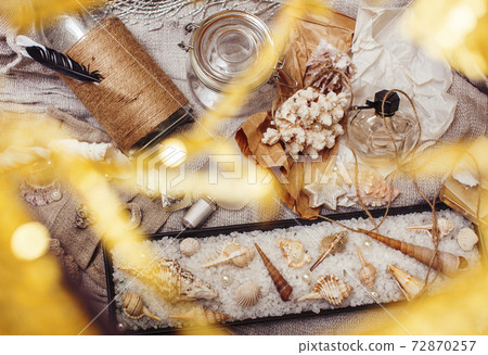 a lot of sea theme in mess like shells, candles, perfume, girl stuff on linen, pretty textured post card view vintage a lot of sea theme in mess like shells, candles, perfume, girl stuff on linen, pretty textured post card view vintage 72870257