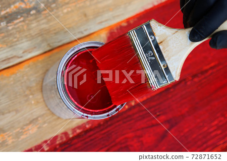 Paint can and brush on the old wooden background. 72871652
