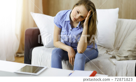 Tired upset woman worried about tiredness from domestic work and self isolation quarantine for COVID-19 Coronavirus Tired upset woman worried about tiredness from domestic work and self isolation quarantine for COVID-19 Coronavirus 72871823