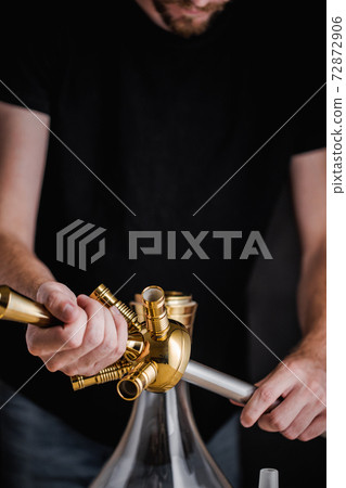 A turkish man show the methode of how to set up a hookah A turkish man show the methode of how to set up a hookah 72872906