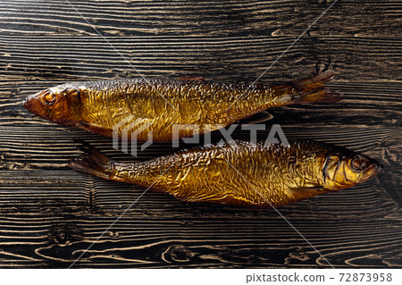 Smocked herring on an old wooden table. Smocked herring on an old wooden table. 72873958