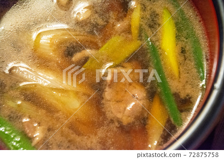 Duck steamer handmade soba soup. Soup with white onion and duck loin. Painted bowl. 72875758