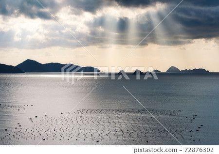 Scenery with a sunset over the Uwakai in Ehime prefecture and a raft for pearl farming 72876302