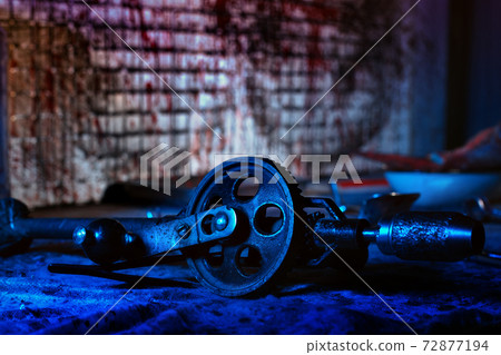 A creepy room with bloodstained walls and medical instruments. A creepy room with bloodstained walls and medical instruments. 72877194