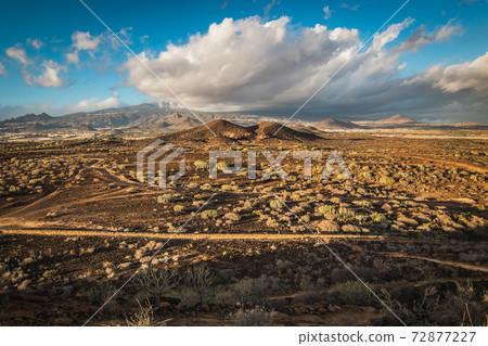 dry arid hot landscape along the hiking trail on a trekking trought Tenerife island, Canary Islands, Spain. dry arid hot landscape along the hiking trail on a trekking trought Tenerife island, Canary Islands, Spain. 72877227
