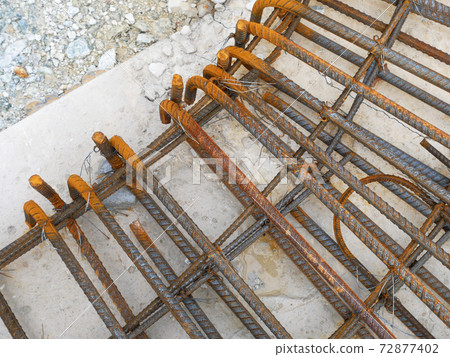 SEREMBAN, MALAYSIA -MARCH 29, 2020: Construction workers fabricating steel reinforcement bar at the construction site. They tied it together using the tiny wires before cover it up using formworks.  72877402