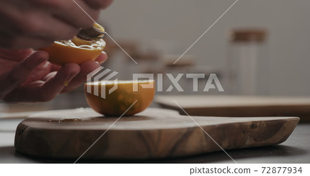 man scoop lulo fruit with a spoon on olive wood board with copy space man scoop lulo fruit with a spoon on olive wood board with copy space 72877934