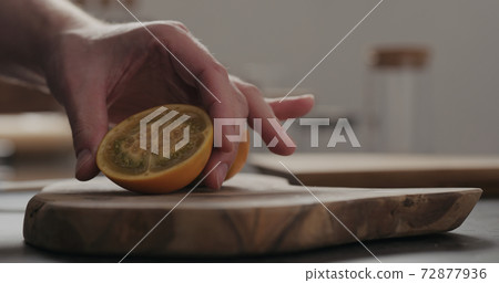 man put sliced lulo fruit on olive wood board with copy space man put sliced lulo fruit on olive wood board with copy space 72877936