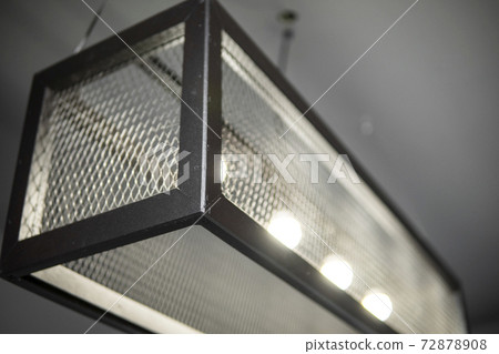 Modern design metal black lamp in a cube form from a metal profiles. Modern loft interior design. Modern design metal black lamp in a cube form from a metal profiles. Modern loft interior design. 72878908
