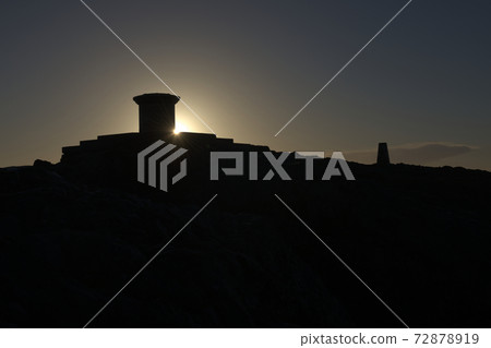 Dark silhouette of malvern hills toposcope and trig point at sunrise Dark silhouette of malvern hills toposcope and trig point at sunrise 72878919