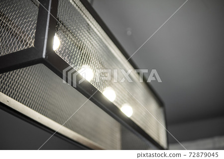 Modern design metal black lamp in a cube form from a metal profiles. Modern loft interior design. Modern design metal black lamp in a cube form from a metal profiles. Modern loft interior design. 72879045