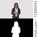 African American businesswoman explaining and gesturing while wa 72880091