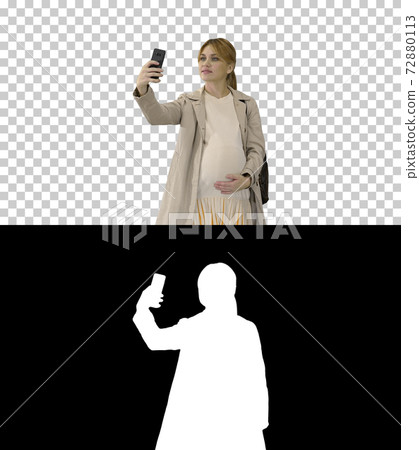 Happy young pregnant woman taking selfie, Alpha Channel with Sil 72880113