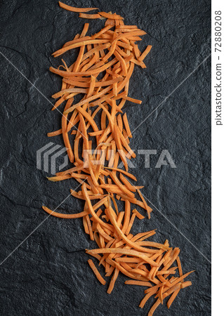 Close up Julienne of fresh carrot over black background Close up Julienne of fresh carrot over black background 72880208