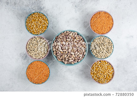 Bunch of various uncooked beans, corns and red lentils on marble surface 72880350