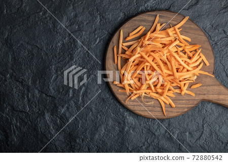 Wide angle julienne of organic fresh carrot on wooden board 72880542