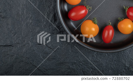 Close up photo of fresh cherry tomatoes inside of pan 72880702