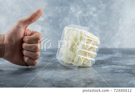 Man hand gesturing thumb up to fresh cheese Man hand gesturing thumb up to fresh cheese 72880812