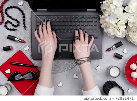 Beautiful groomed woman's hands typing at keyboard on the home office table Beautiful groomed woman's hands typing at keyboard on the home office table 72881471