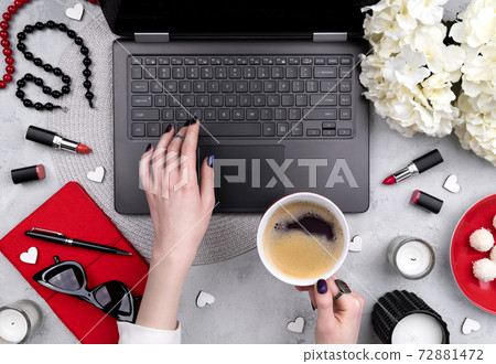 Beautiful groomed woman's hands typing at keyboard on the home office table 72881472