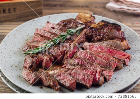 grilled red beef pork meat barbecue steak fillet with rosemary sprig and hot sauce served on plate 72881563