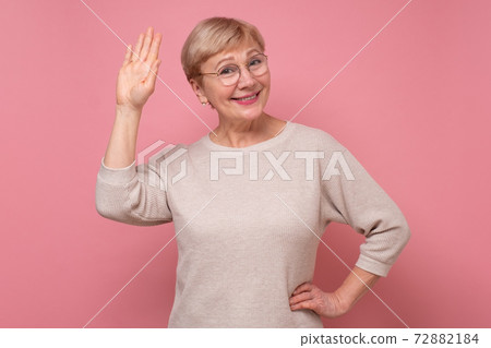 Beautiful caucasian woman waiving saying hello happy and smiling, friendly welcome gesture. 72882184