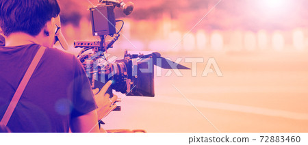 Film industry. Filming with professional camera. Videographer holding 4k cam on dslr rig or gimbal stabilizer set. Pro equipment helps to make videos without shaking. video production. 72883460