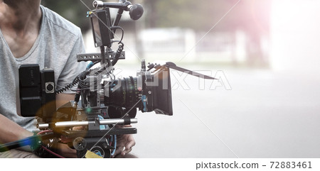 Film industry. Filming with professional camera. Videographer holding 4k cam on dslr rig or gimbal stabilizer set. Pro equipment helps to make videos without shaking. video production. 72883461