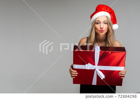 cheerful woman in black dress and cristmas hat cheerful woman in black dress and cristmas hat 72884298