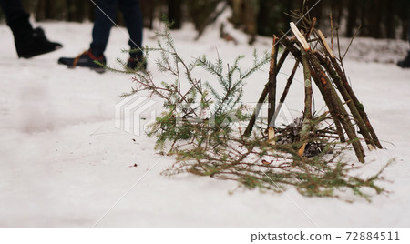 Tourists at a halt. Preparation for making a fire from spruce branches 72884511