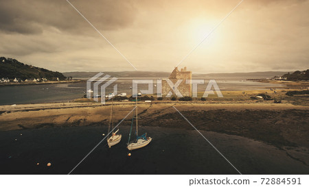 Sun seascape at castle ruins aerial. Ocean coast with yachts, ships. Historic heritage landmark Sun seascape at castle ruins aerial. Ocean coast with yachts, ships. Historic heritage landmark 72884591