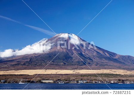 Yamanakako Village, Yamanashi Prefecture, where you can see Mt. Fuji from the vicinity of Nagaike Water Park in Lake Yamanaka, which has less snowfall in December on a winter morning. 72887231