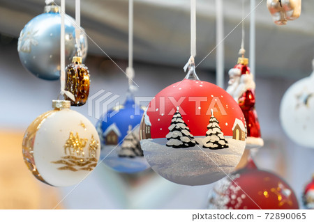 Christmas glass ball ornaments at a Christmas market in Milan, Europe. Buying presents and gifts in street market. 72890065