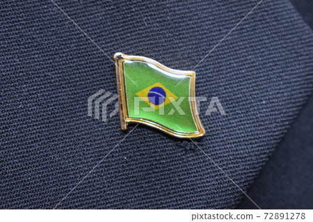 Brazil flag lapel pin on a suit Brazil flag lapel pin on a suit 72891278