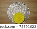 Yellow pickled radish flower shape on gold base. A flower made of radish. Yellow flower shape. 72891622