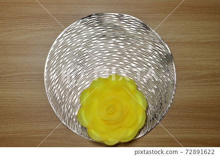 Yellow pickled radish flower shape on gold base. A flower made of radish. Yellow flower shape. Yellow pickled radish flower shape on gold base. A flower made of radish. Yellow flower shape. 72891622