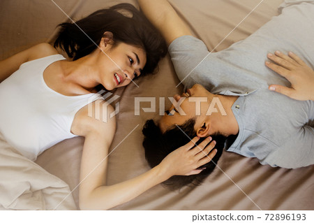 Top view of romantic young couple lying in the bed. 72896193