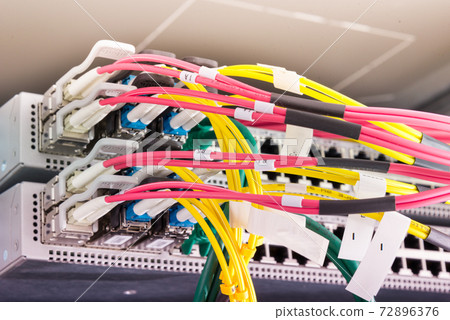 fiber optic cables plugged in network switch 72896376