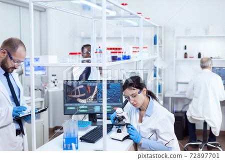 Scientist doing using microscope for medicine study Scientist doing using microscope for medicine study 72897701