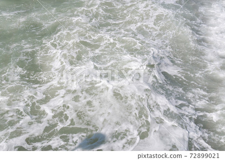 Waves break on the shore. Texture of the water surface near the shore sea natural background. 72899021