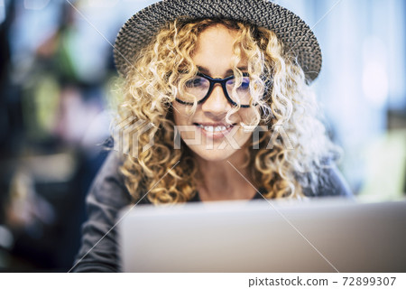 Smart work in travel lifestyle for beautiful trendy caucasian young woman use  laptop computer in bar or airport gate modern alternative free office concept - portrait of pretty female people with 72899307