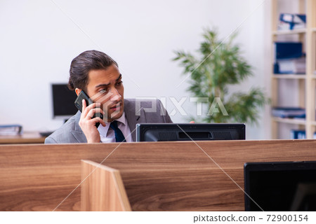 Young male employee working in the office Young male employee working in the office 72900154