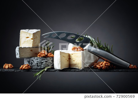 Various soft cheeses with walnuts and rosemary. Various soft cheeses with walnuts and rosemary. 72900569