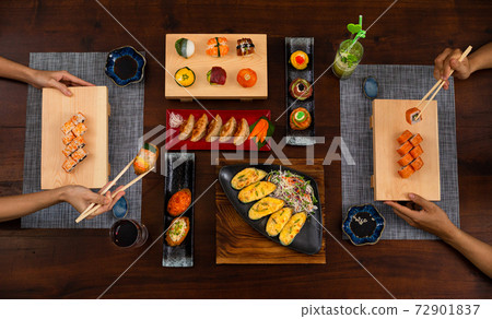Top view of a couple enjoying Japanese cuisine various side dishes 72901837