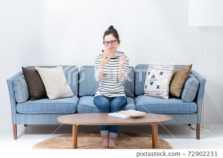 Young woman with smartphone and card Young woman with smartphone and card 72902231