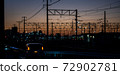 Overhead line against the backdrop of the madder-colored sunset 72902781