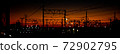 Overhead line against the backdrop of the madder-colored sunset 72902795