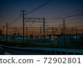 Overhead line against the backdrop of the madder-colored sunset 72902801