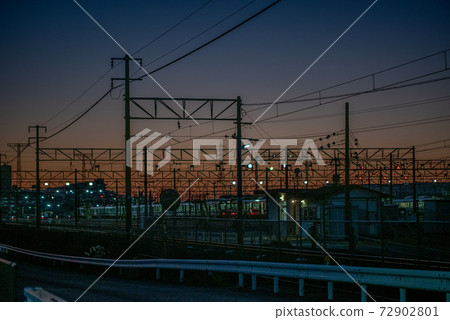 Overhead line against the backdrop of the madder-colored sunset Overhead line against the backdrop of the madder-colored sunset 72902801